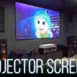 Home theater: a large wall projector screen shows a colorful cartoon, with surround speakers and AV gear around it, and a glowing text overlay reading 'PROJECTOR SCREENS'.